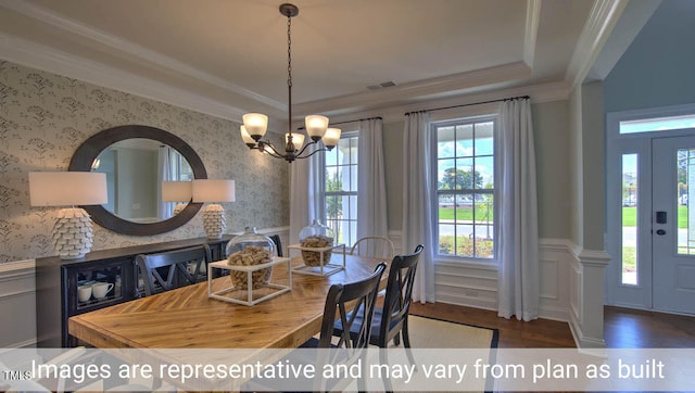 dining room featuring crown molding, dark wood-type flooring, and a chandelier