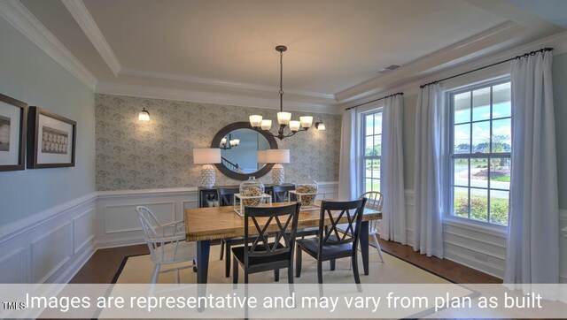 dining room with an inviting chandelier, a healthy amount of sunlight, and dark hardwood / wood-style flooring