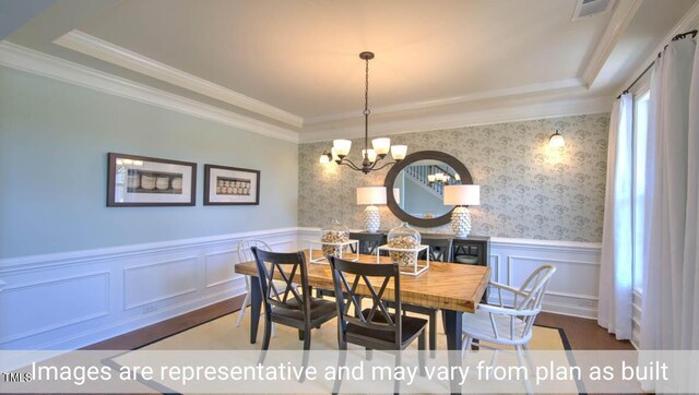 dining space featuring an inviting chandelier, crown molding, and hardwood / wood-style floors