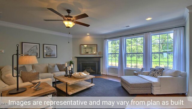 living room featuring hardwood / wood-style flooring, ornamental molding, and a healthy amount of sunlight