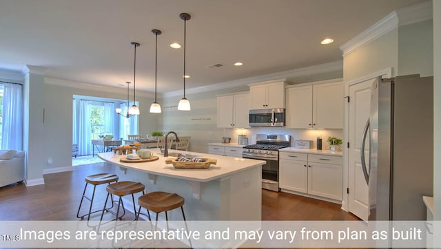 kitchen featuring white cabinets, a kitchen island with sink, stainless steel appliances, and hanging light fixtures