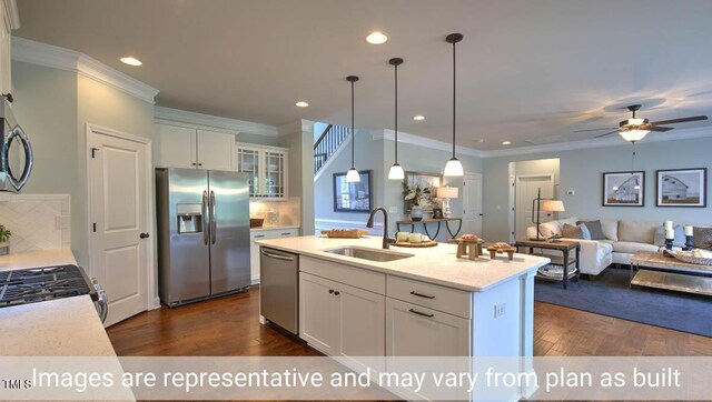 kitchen with white cabinets, backsplash, appliances with stainless steel finishes, and sink