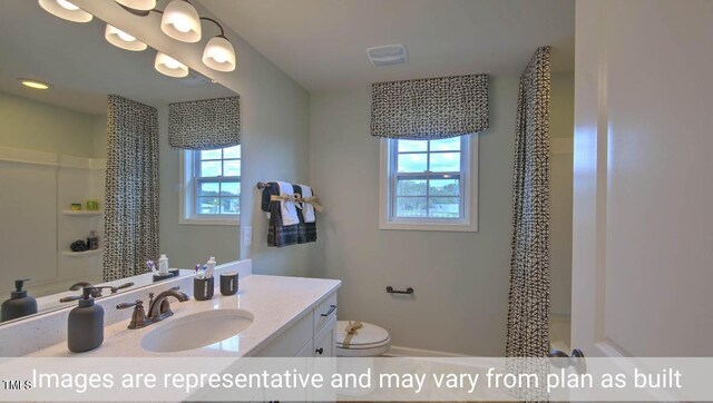 bathroom with a shower with curtain, toilet, and plenty of natural light