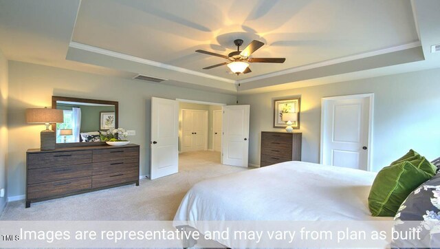 bedroom featuring a raised ceiling, light carpet, and ceiling fan