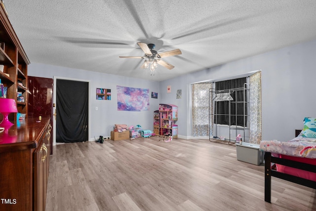 interior space featuring a textured ceiling, ceiling fan, and light hardwood / wood-style flooring