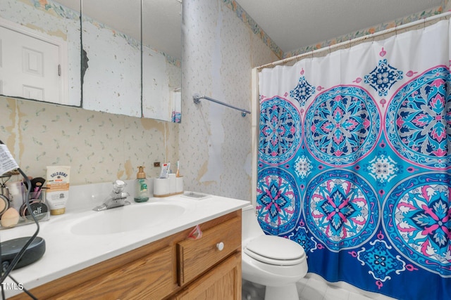 bathroom with vanity, toilet, a textured ceiling, and a shower with shower curtain