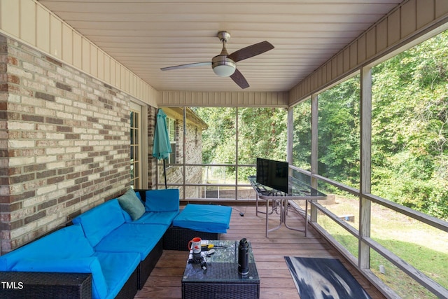 unfurnished sunroom featuring ceiling fan