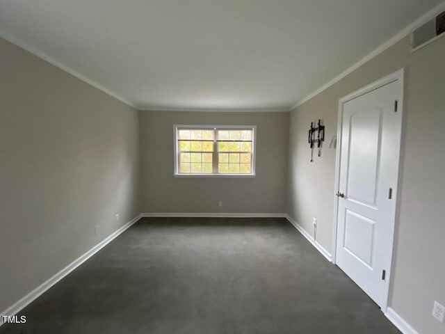 carpeted spare room with crown molding