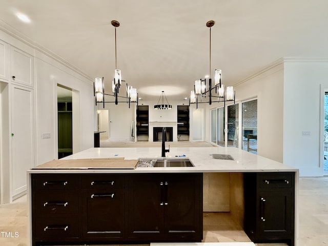 kitchen featuring pendant lighting, crown molding, a center island, and sink