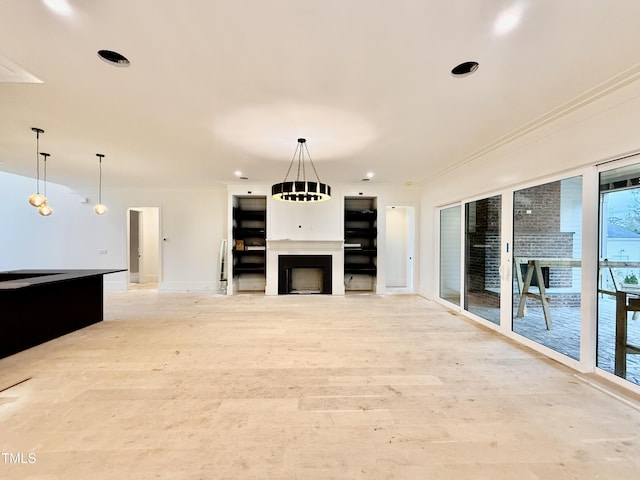 unfurnished living room with crown molding and light hardwood / wood-style floors