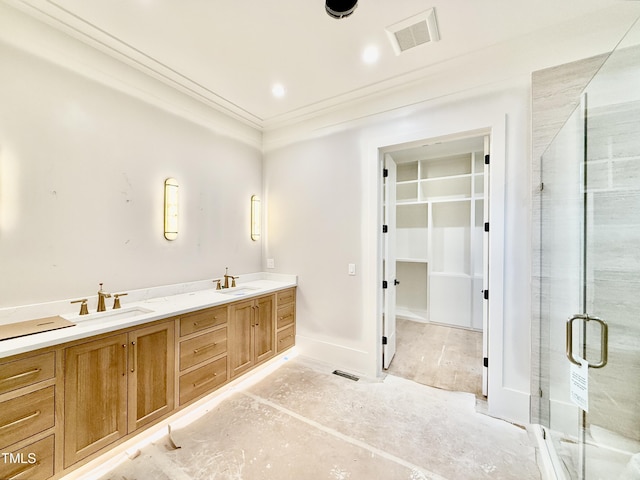 bathroom featuring a shower with door, vanity, and ornamental molding