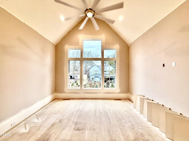 additional living space with vaulted ceiling, ceiling fan, and light wood-type flooring