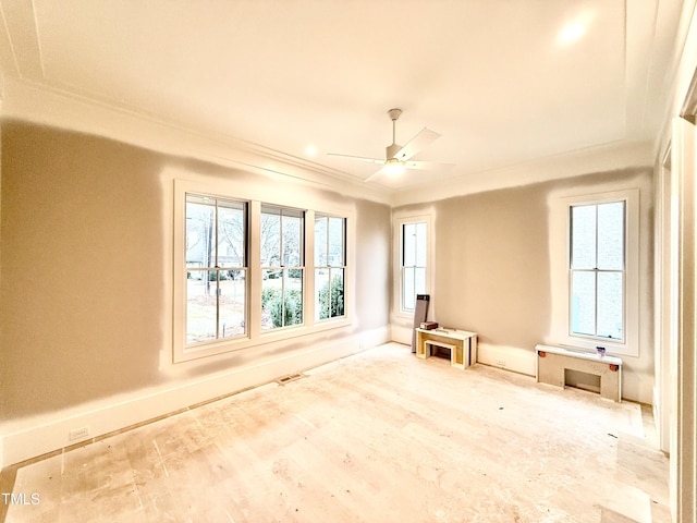 spare room featuring crown molding, ceiling fan, and light hardwood / wood-style flooring