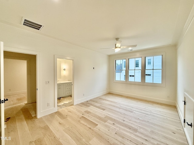 unfurnished bedroom with ceiling fan, ensuite bath, and light hardwood / wood-style floors