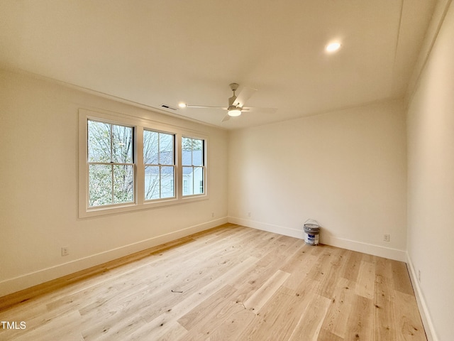 spare room with ceiling fan and light wood-type flooring