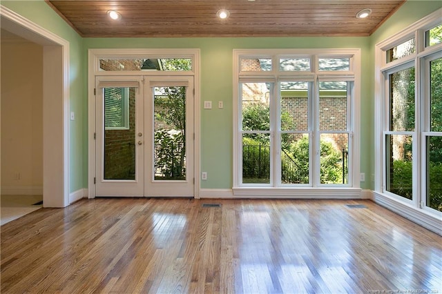 doorway to outside featuring plenty of natural light, lofted ceiling, wooden ceiling, and light wood-type flooring