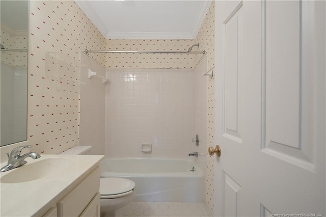 full bathroom with crown molding, vanity, toilet, and tiled shower / bath