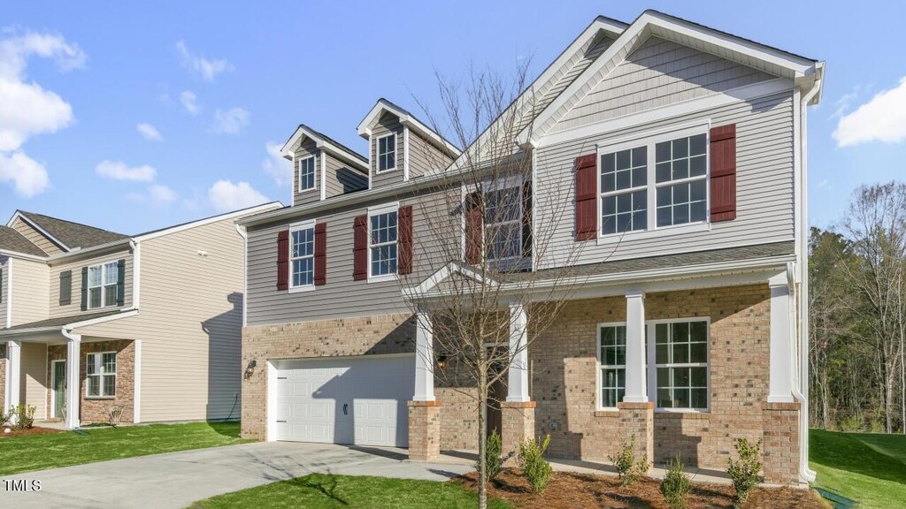 view of front of property featuring a garage and covered porch