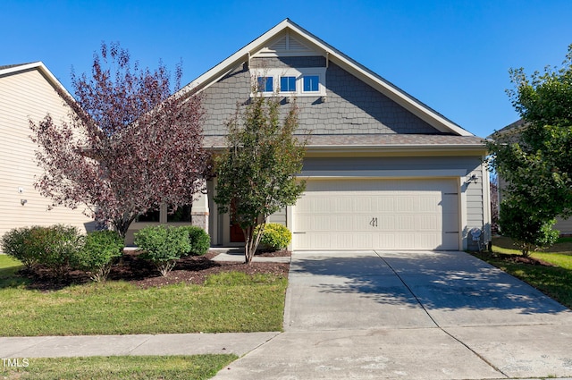 view of front of house with a garage and a front yard