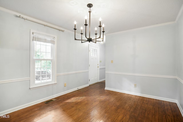 unfurnished dining area featuring ornamental molding, hardwood / wood-style flooring, and a chandelier