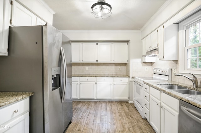 kitchen with light hardwood / wood-style floors, white cabinets, stainless steel appliances, ornamental molding, and sink