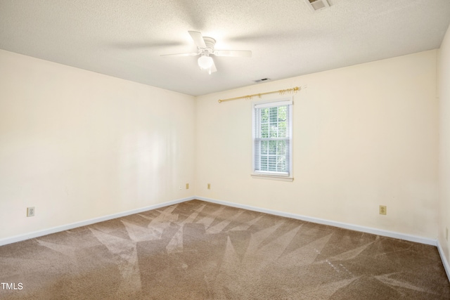 empty room featuring ceiling fan, a textured ceiling, and carpet flooring