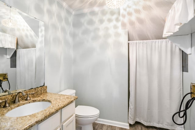 bathroom with vanity, crown molding, toilet, and hardwood / wood-style flooring