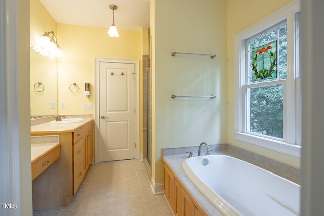 bathroom featuring vanity, plus walk in shower, plenty of natural light, and tile patterned floors