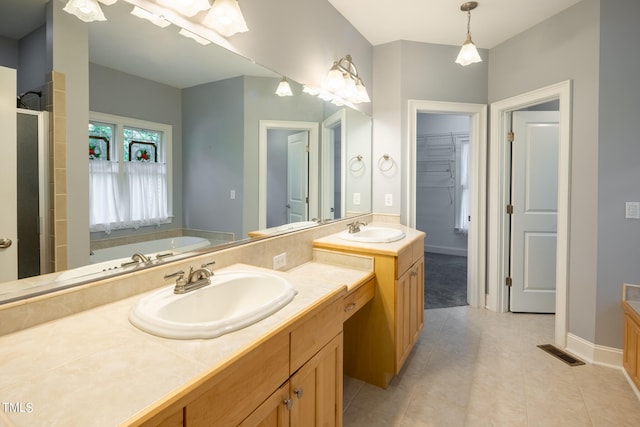 bathroom with vanity, a shower with shower door, and tile patterned flooring