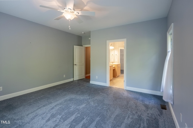 unfurnished bedroom with ensuite bathroom, ceiling fan, and carpet