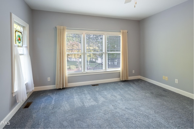 unfurnished room featuring ceiling fan and carpet flooring