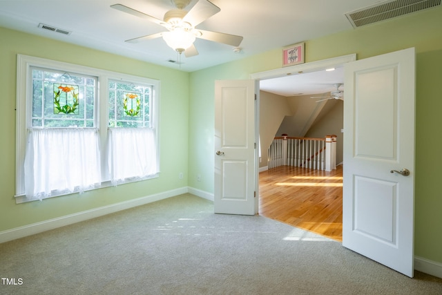 carpeted empty room with ceiling fan