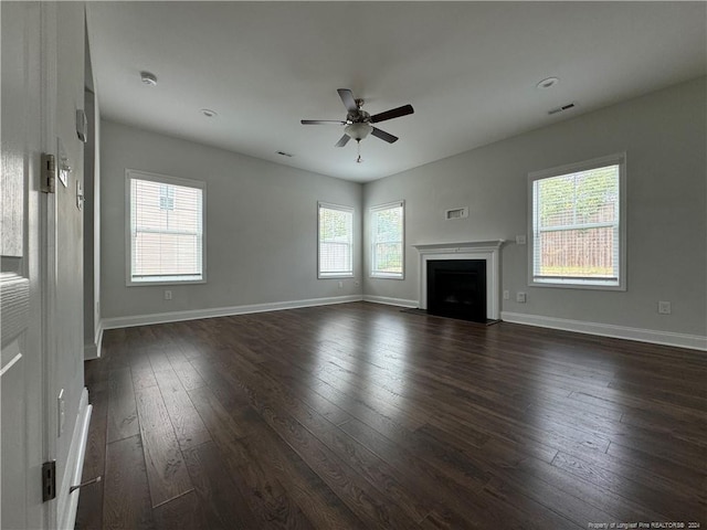 unfurnished living room featuring ceiling fan and dark hardwood / wood-style flooring