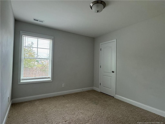 unfurnished room with light colored carpet