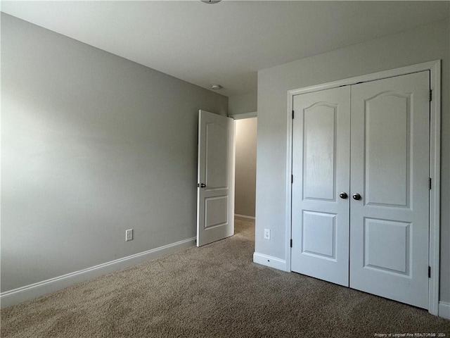 unfurnished bedroom with carpet and a closet