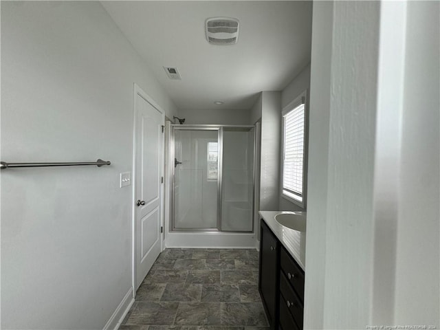 bathroom featuring walk in shower and vanity