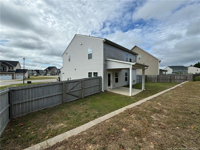 back of property with a patio and a lawn