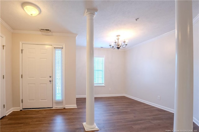 entryway with visible vents, ornamental molding, an inviting chandelier, and dark wood finished floors