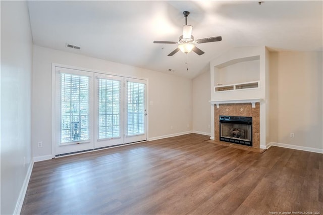 unfurnished living room featuring visible vents, a ceiling fan, wood finished floors, and a tile fireplace
