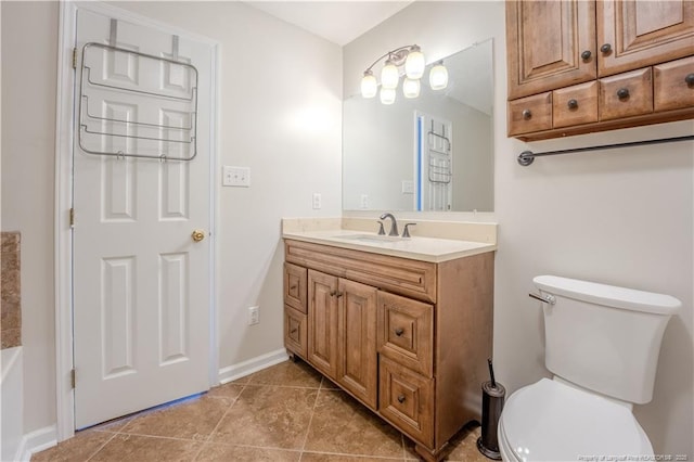 bathroom featuring vanity, tile patterned flooring, baseboards, and toilet