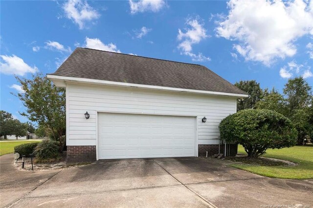 view of home's exterior with a yard and a garage