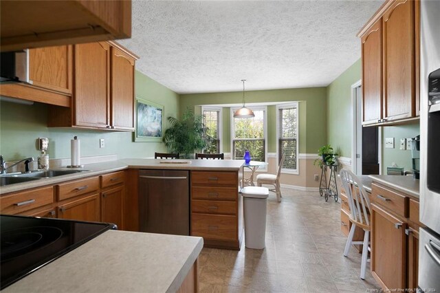 kitchen with pendant lighting, dishwasher, black range, and a textured ceiling