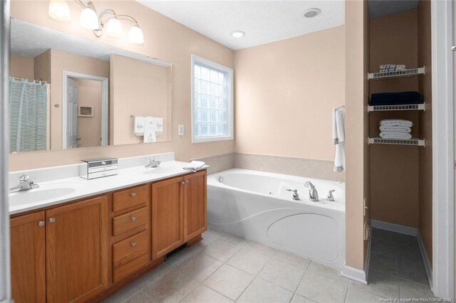 bathroom with vanity, a tub to relax in, and tile patterned floors