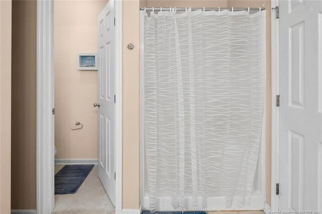 interior space featuring a shower with curtain and tile patterned floors