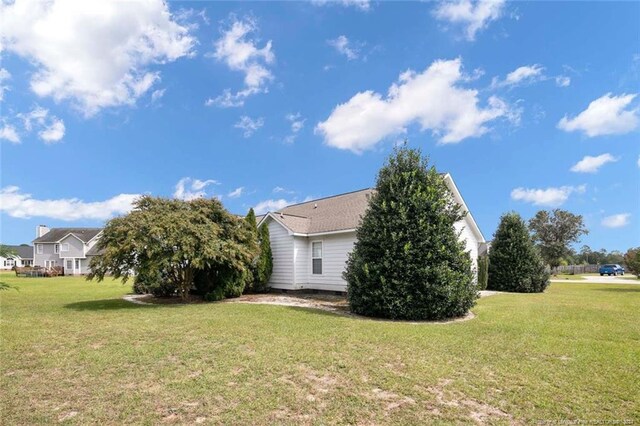 view of side of home featuring a yard