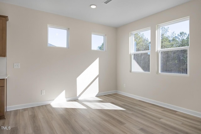 empty room with light hardwood / wood-style floors