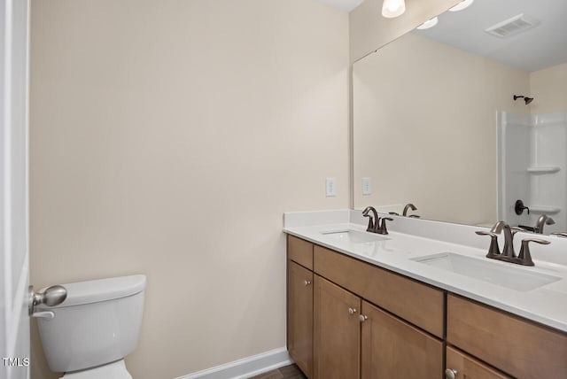 bathroom with toilet, a shower, and vanity