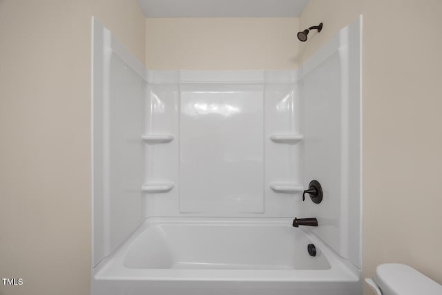 bathroom featuring toilet and  shower combination