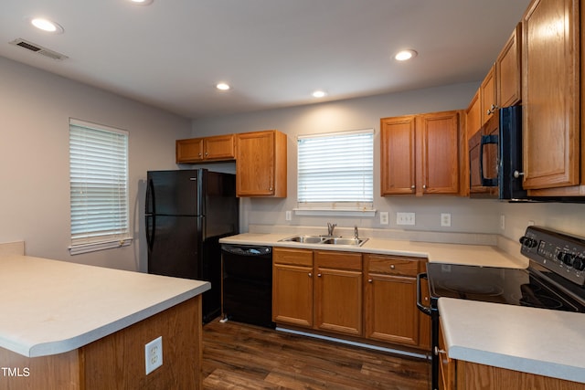 kitchen featuring dark hardwood / wood-style floors, sink, and black appliances