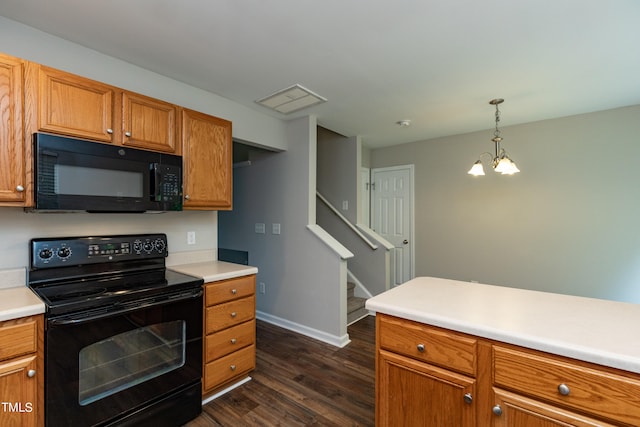 kitchen with pendant lighting, black appliances, a notable chandelier, and dark wood-type flooring